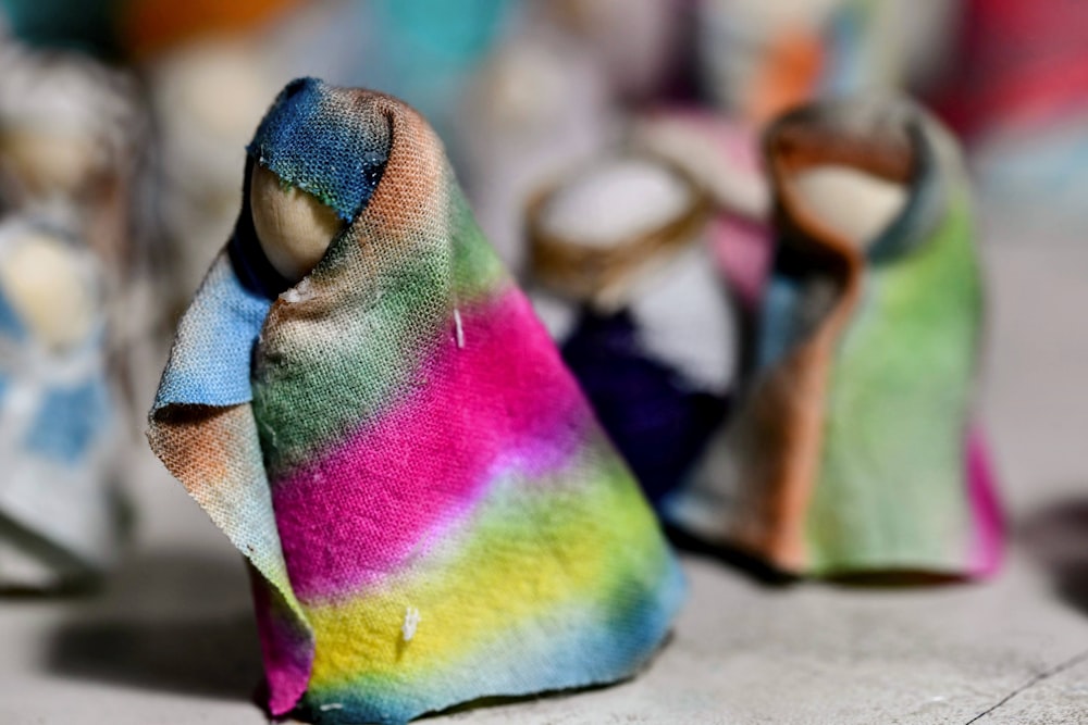 a group of cloth dolls sitting on top of a table