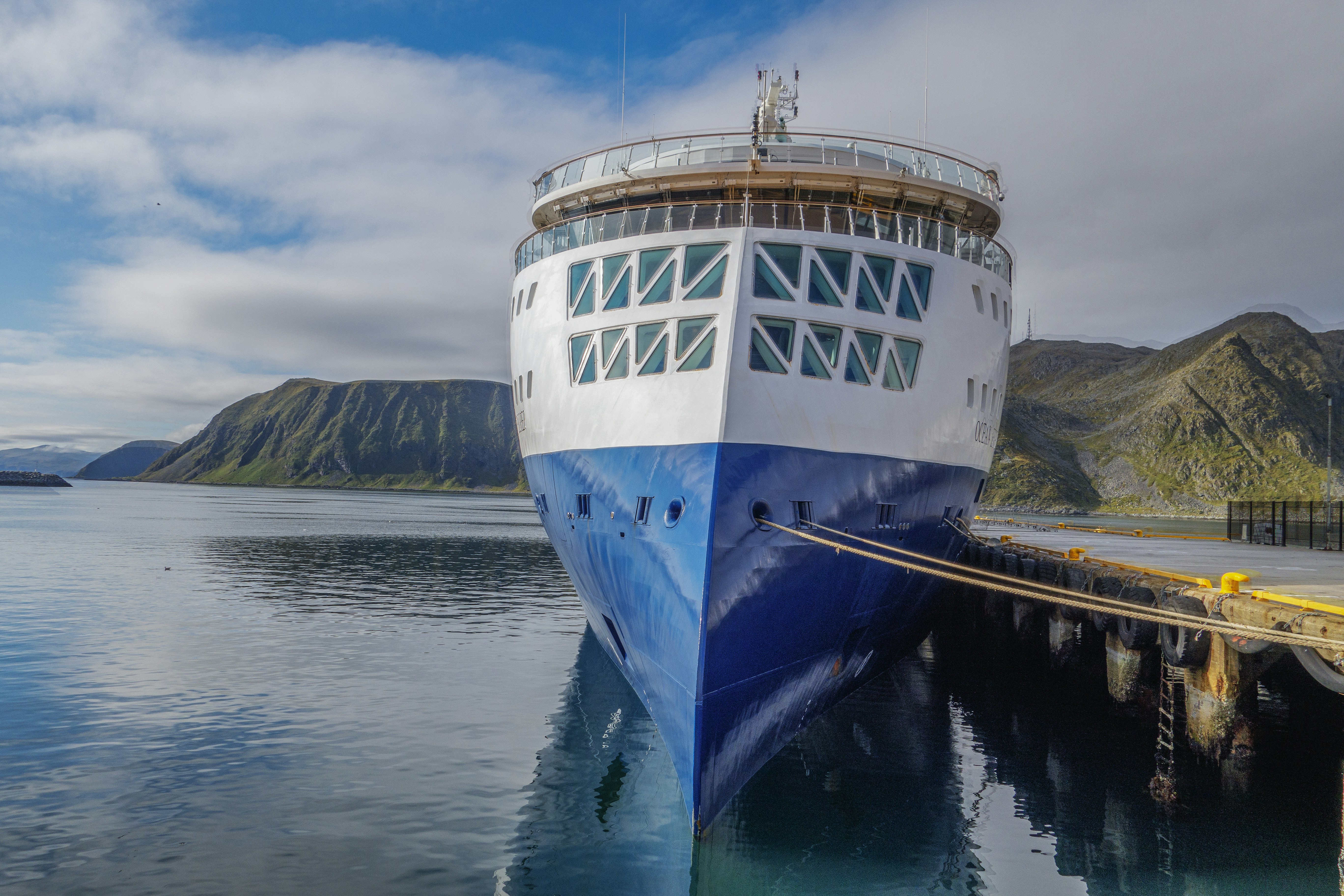 a large blue and white boat docked at a dock