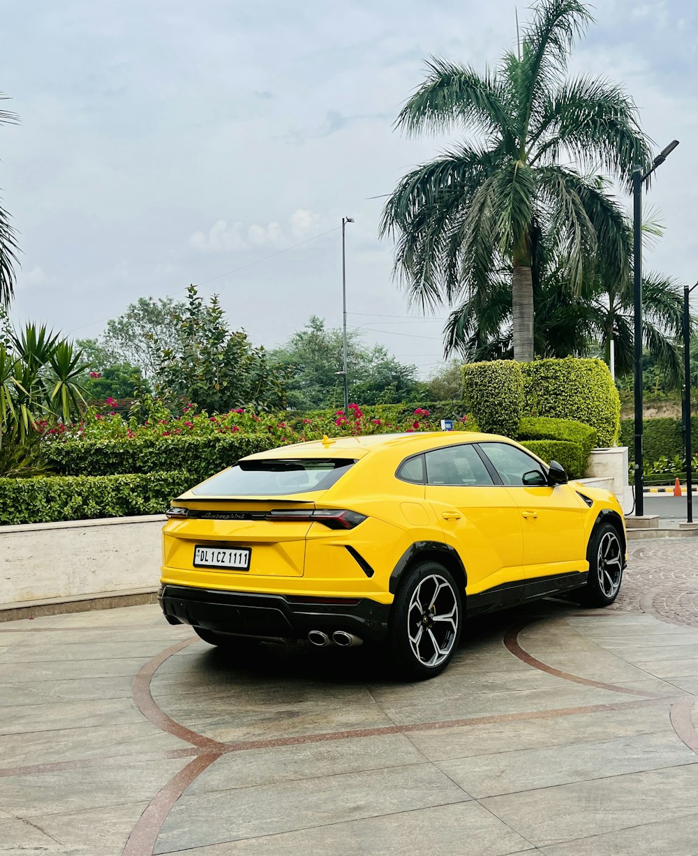 a yellow lamb suv parked in a parking lot