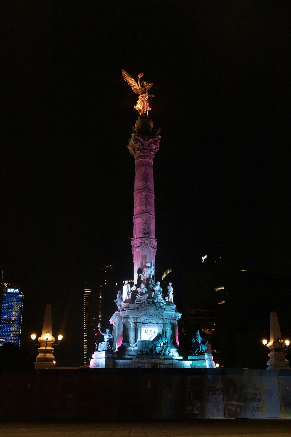 a statue with a bird on top of it at night