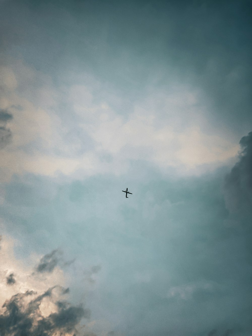 an airplane is flying through a cloudy sky