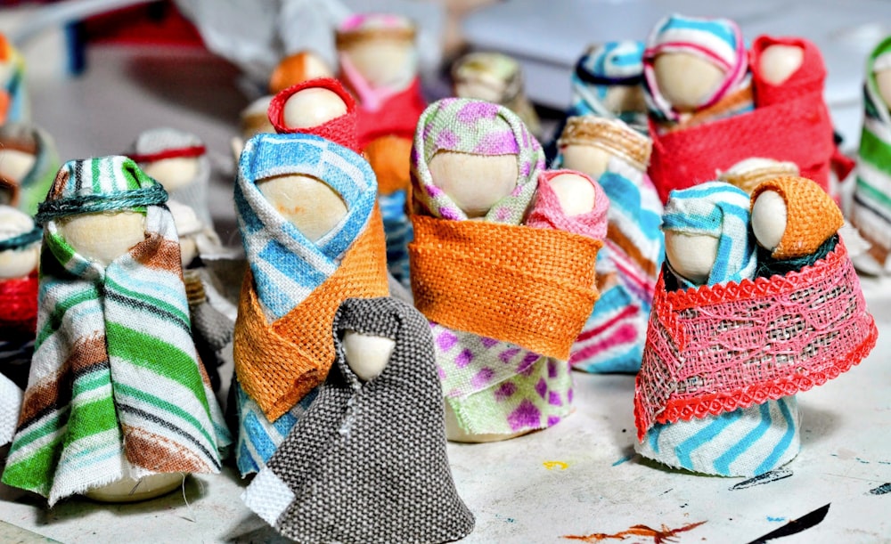 a group of cloth dolls sitting on top of a table