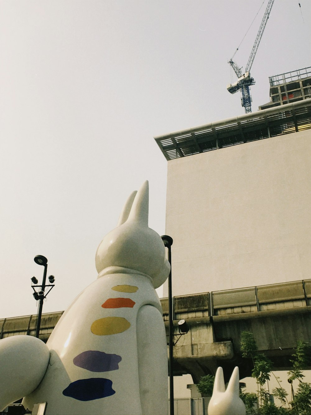 a statue of a dog with a building in the background