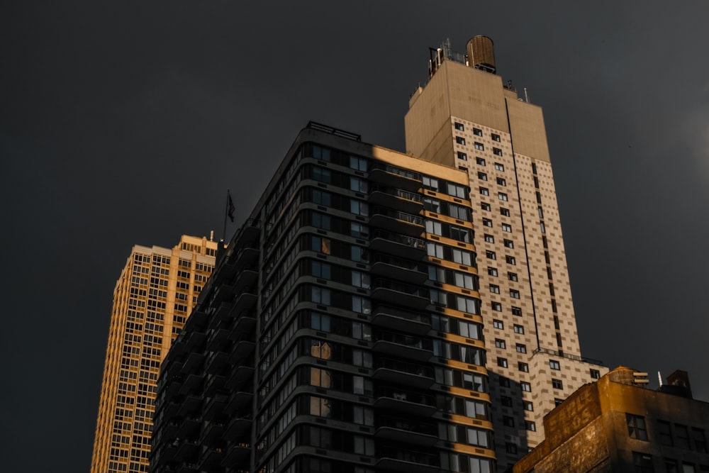 a very tall building with a very dark sky in the background