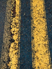 two yellow lines are painted on the asphalt
