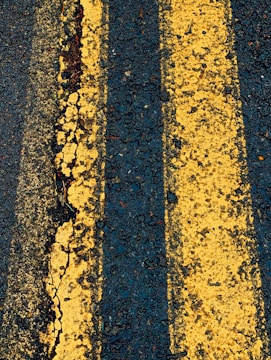 two yellow lines are painted on the asphalt