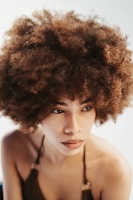 a woman with an afro is posing for a picture