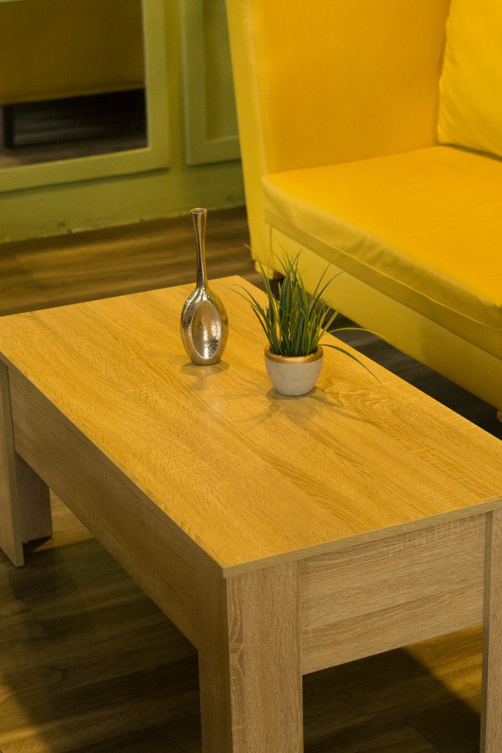 a wooden table with a potted plant on top of it