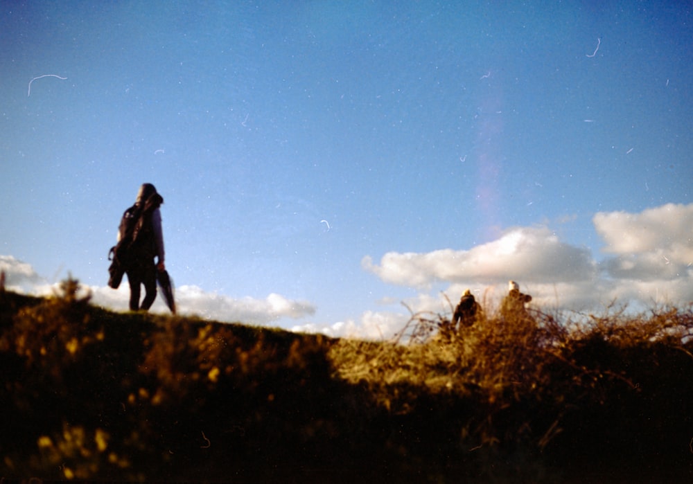 a person walking up a hill on a sunny day