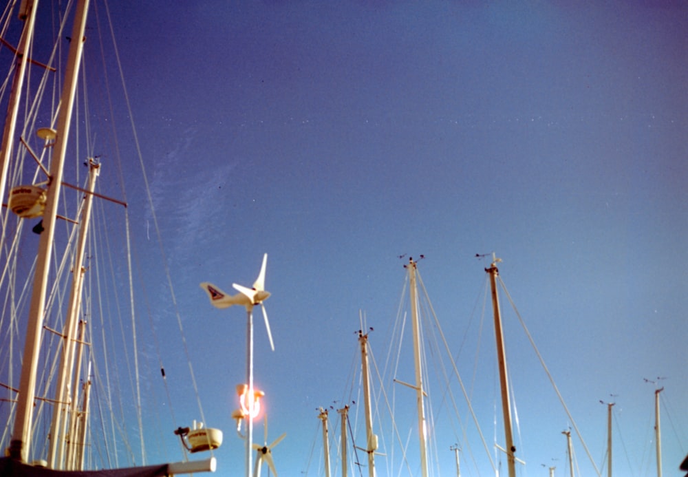 a plane is flying over a bunch of masts