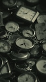 a pile of clocks sitting on top of each other