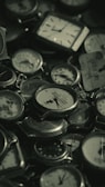 a pile of clocks sitting on top of each other