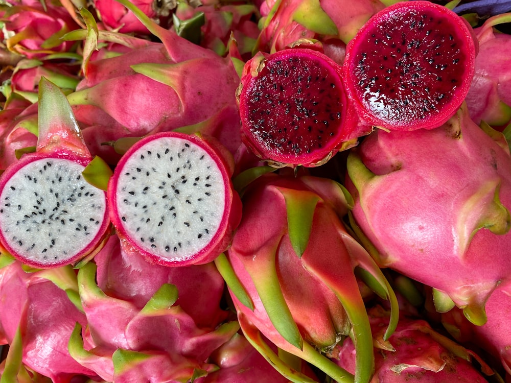 a pile of dragon fruit cut in half