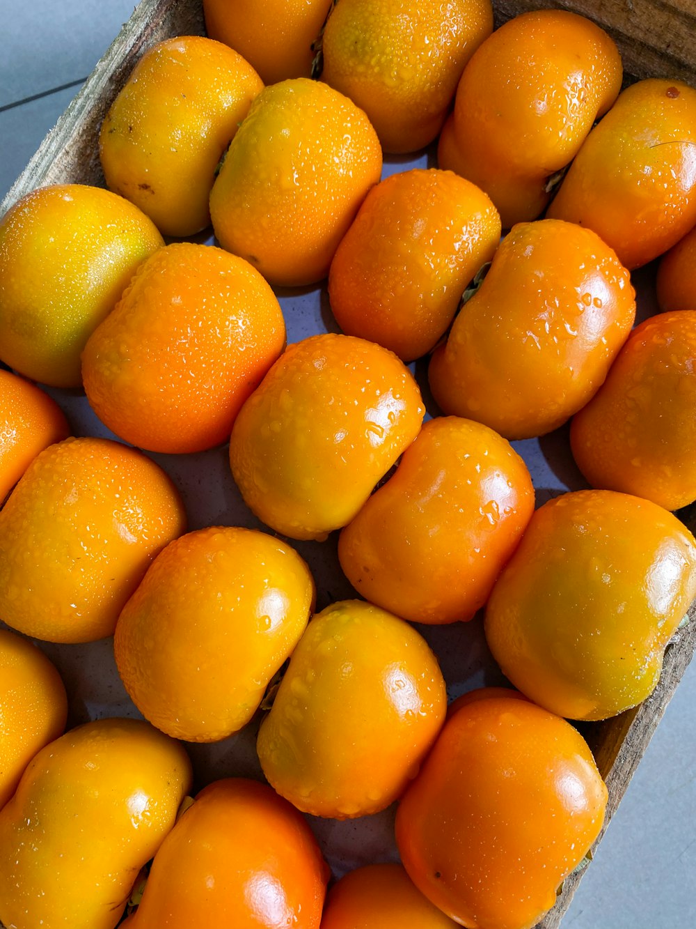 a box filled with lots of oranges on top of a table