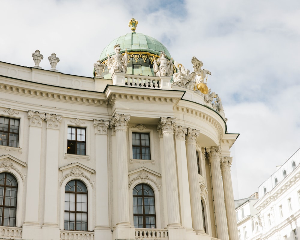 a large white building with a green dome