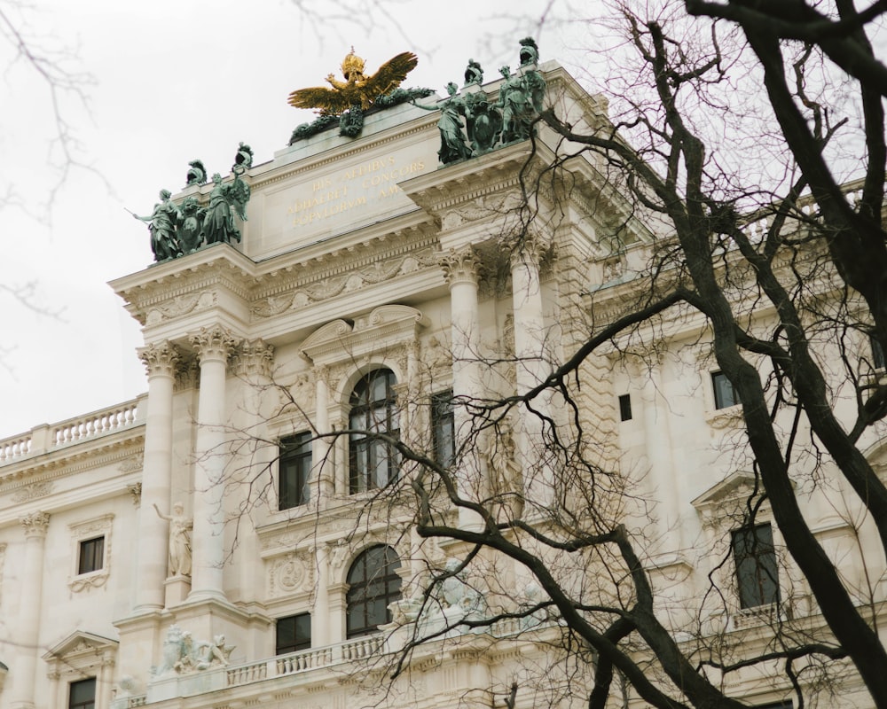 a large white building with a golden eagle on top