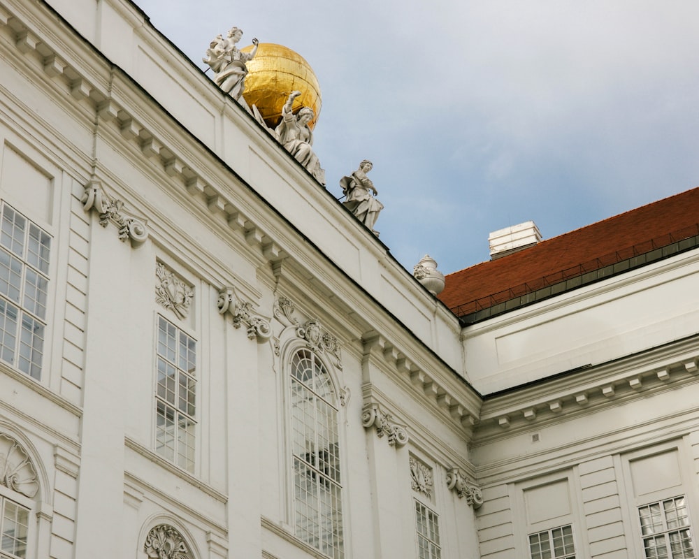 a large white building with statues on top of it