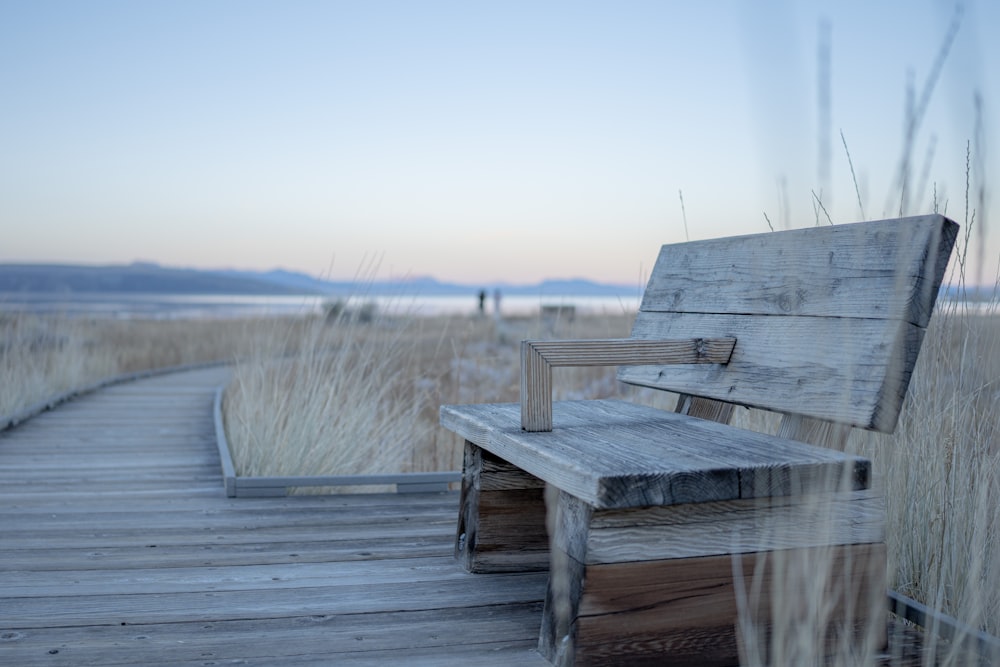 a wooden bench sitting on top of a wooden walkway