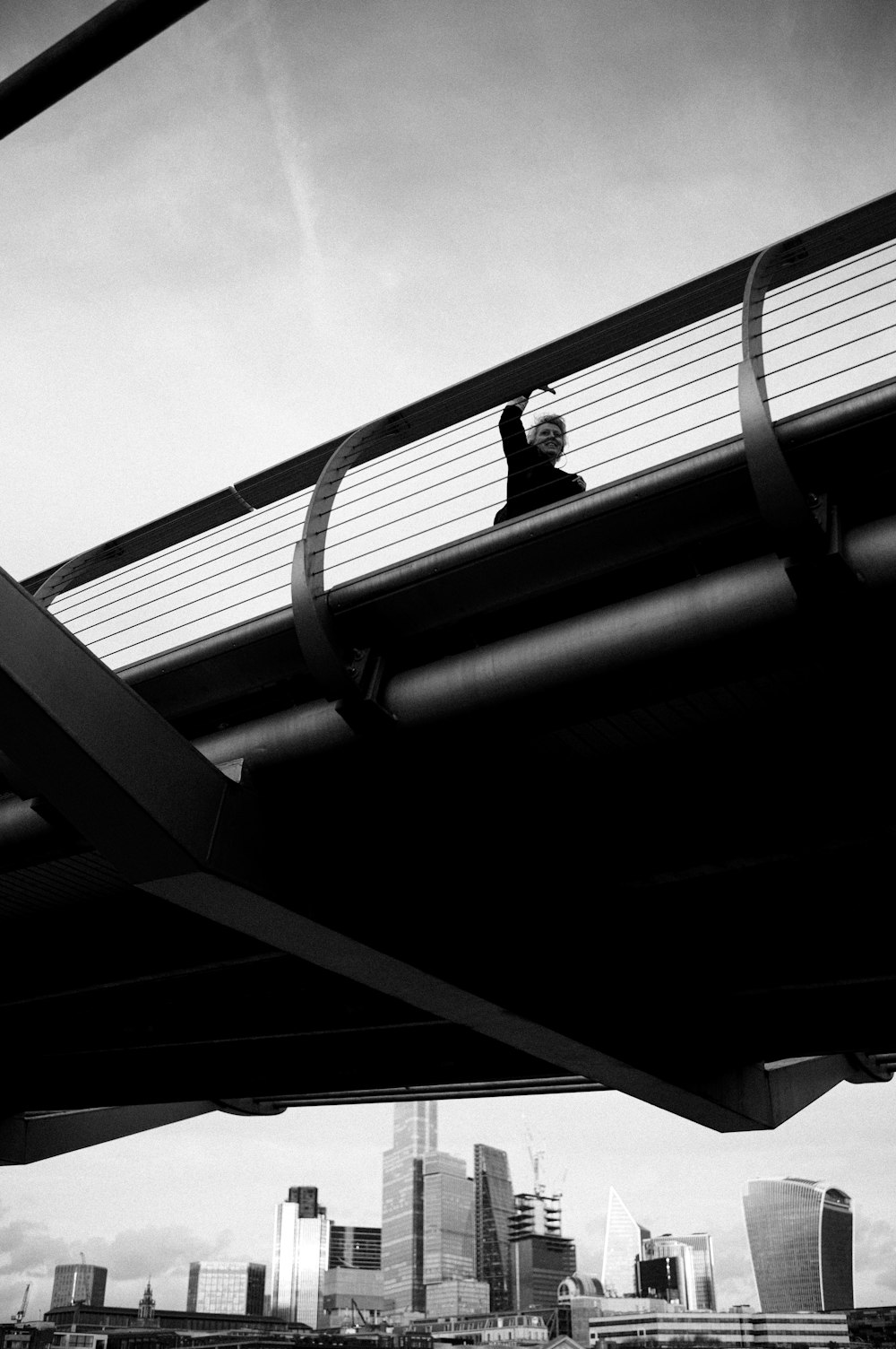 a man riding a skateboard across a bridge