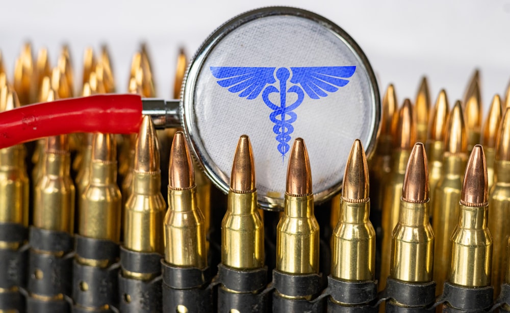 a close up of a magnifying glass over a bunch of bullet casings