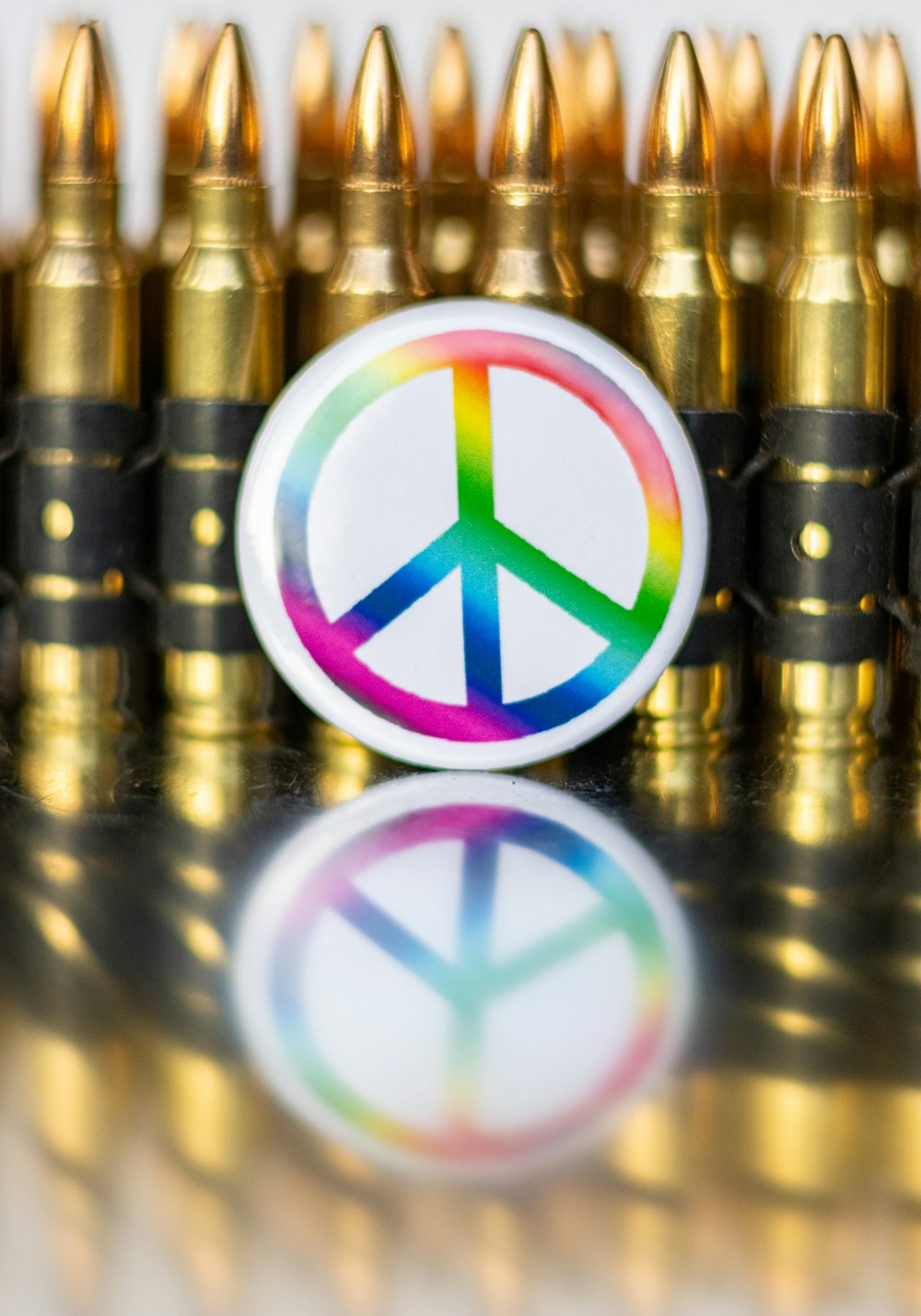 a peace sign sticker on top of a bunch of bullet shells