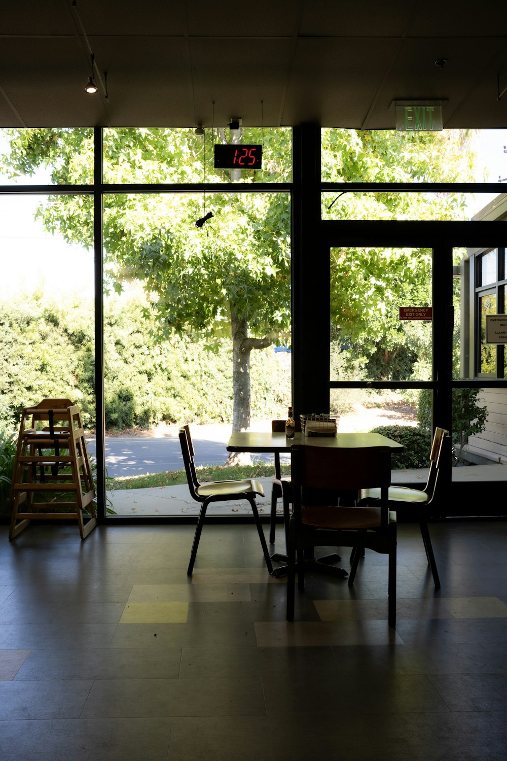 a table and chairs in a room with large windows