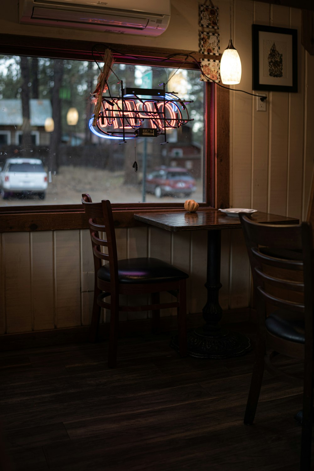 a restaurant with a table and chairs in front of a window