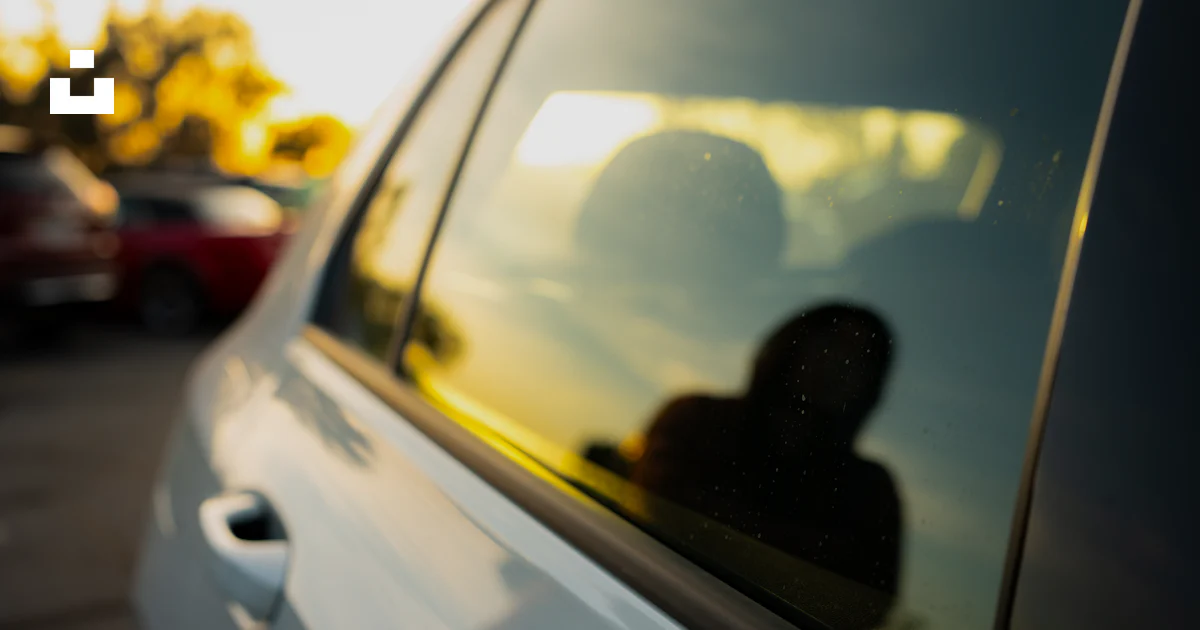 Reflection In Car Window A reflection of a person in a car window photo – Free Automobile Image ...