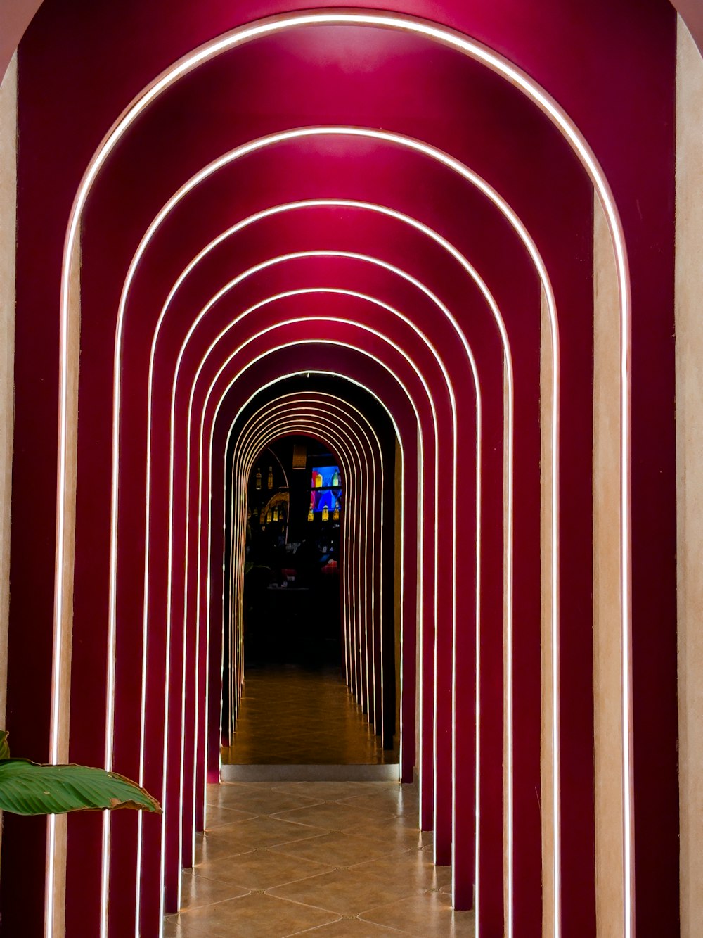 a very long hallway with a bunch of arches