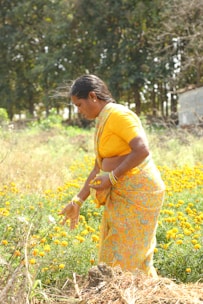a woman standing in a field of yellow flowers