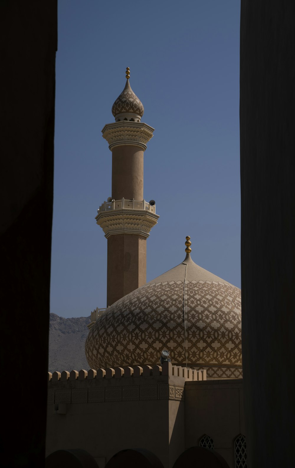 a tall building with a dome and a clock on it