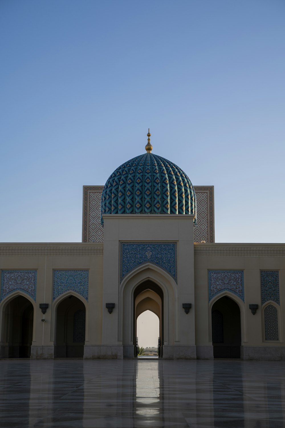 a large white building with a blue dome