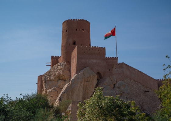 a large castle with a flag on top of it