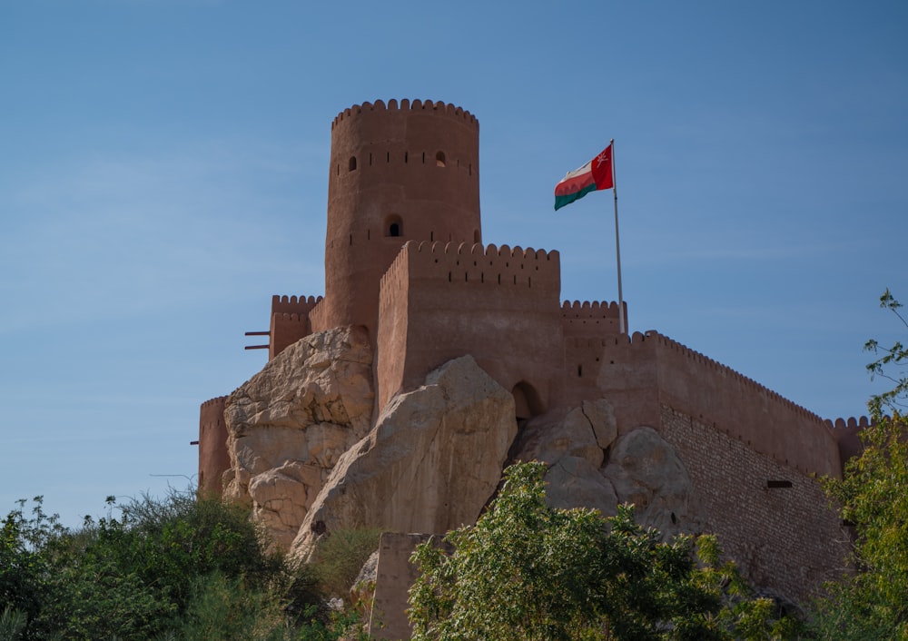 a large castle with a flag on top of it