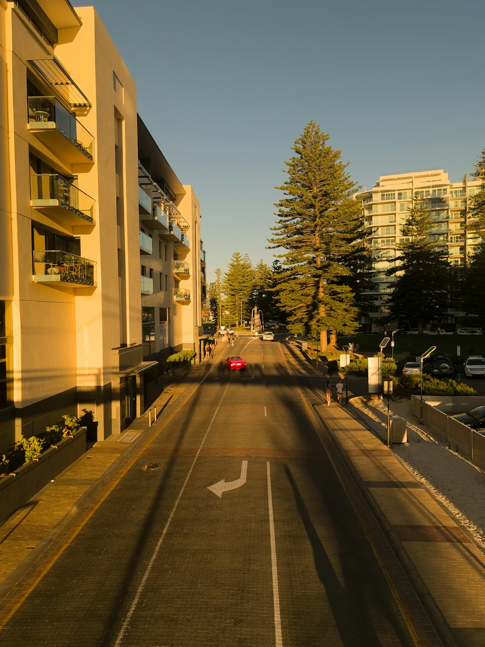 a car driving down a street next to tall buildings