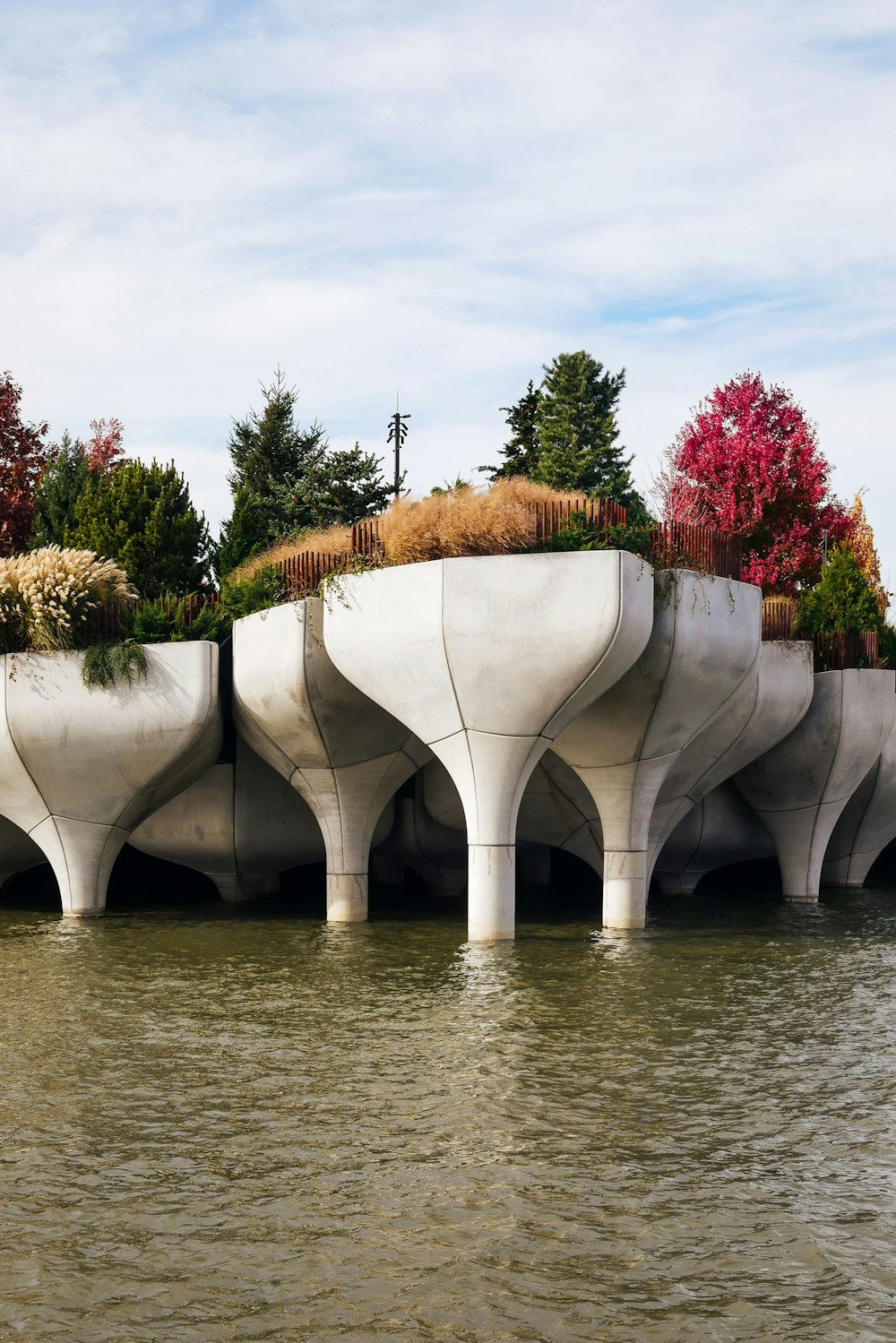 a group of concrete structures sitting on top of a lake
