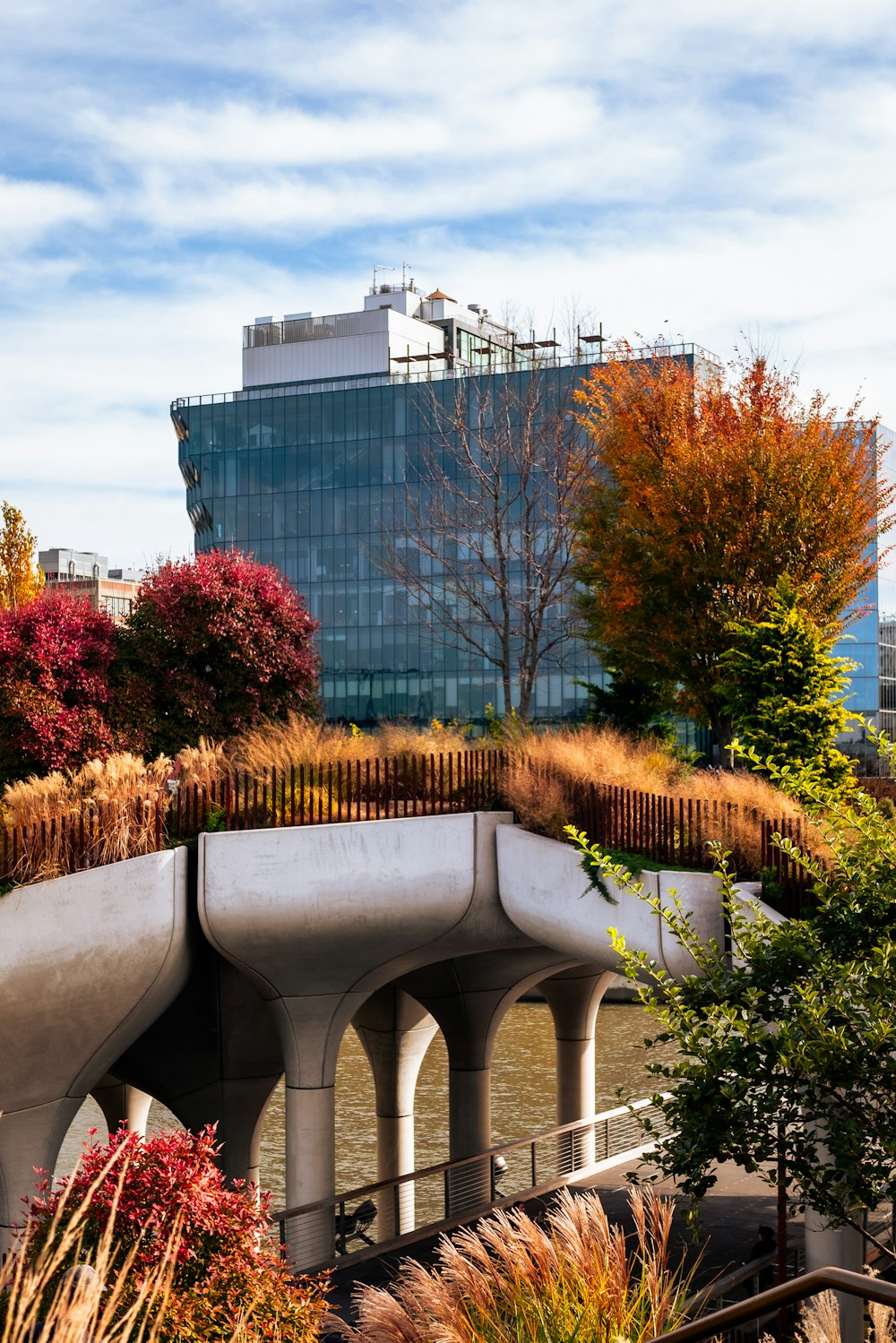 a building with a green roof next to a body of water