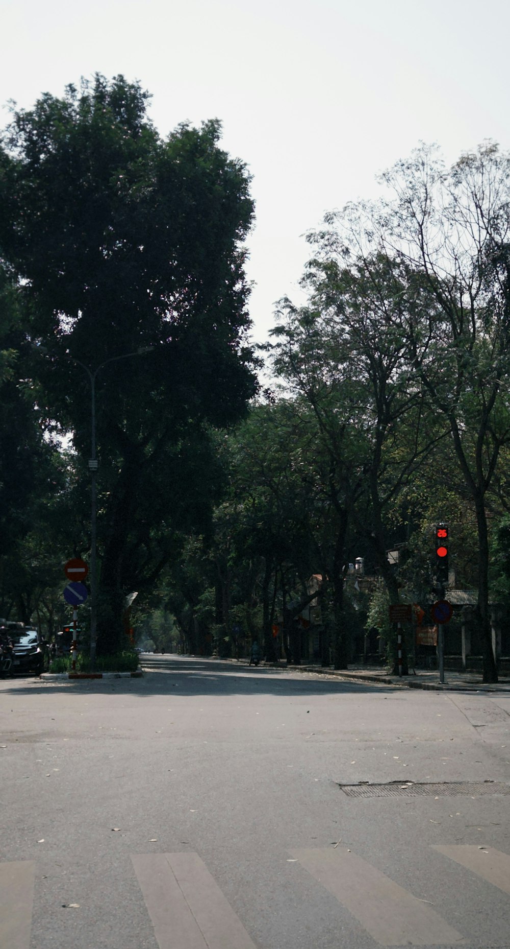 an empty street with a red traffic light