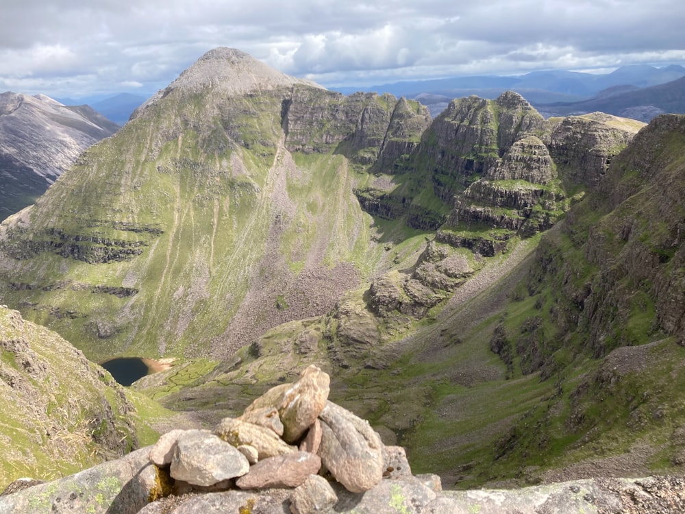 a view of a mountain range with rocks and grass