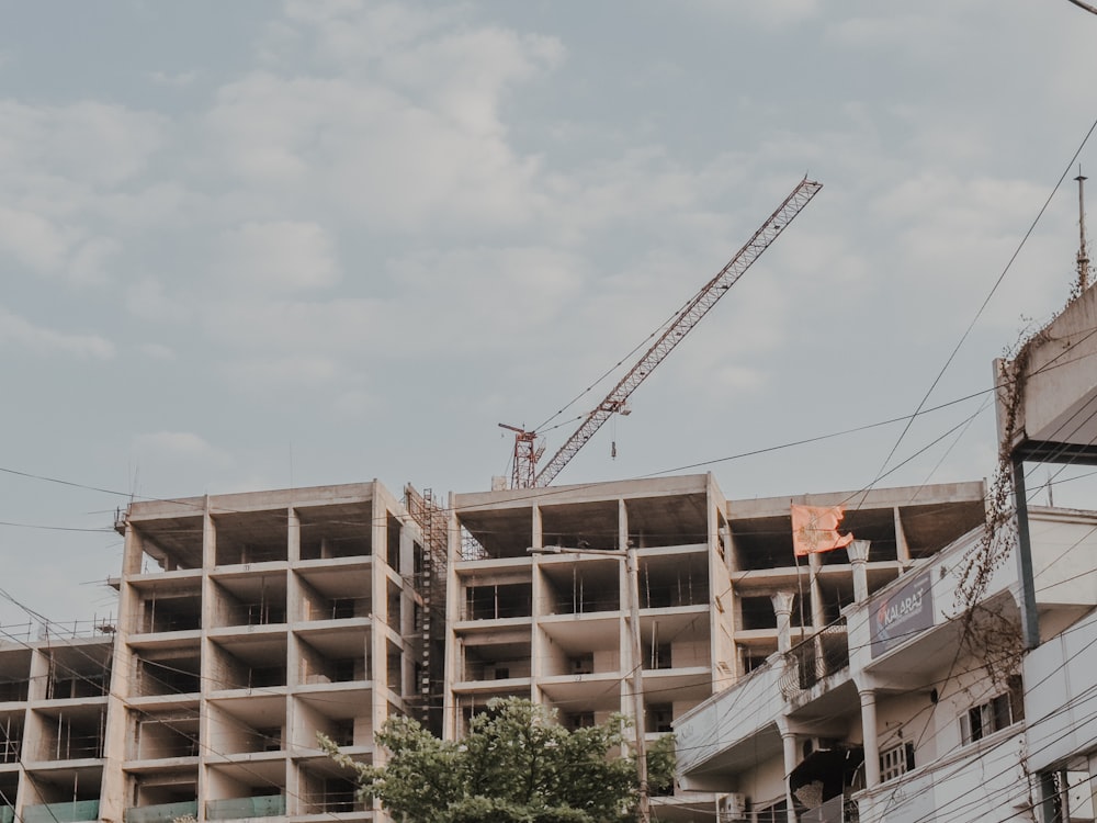 a building under construction with a crane in the background