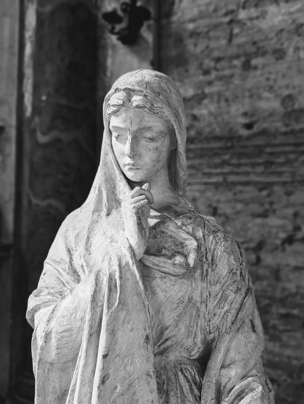 a black and white photo of a statue of a woman