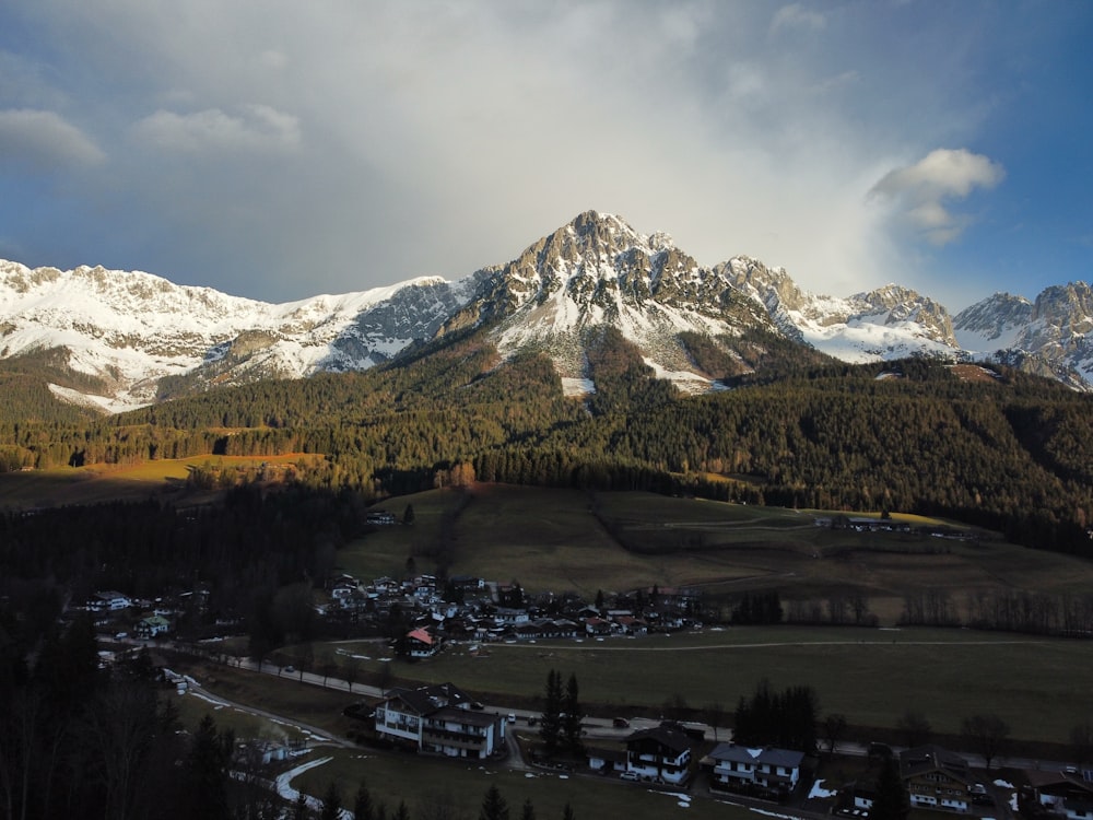 a view of a mountain range with a village in the foreground