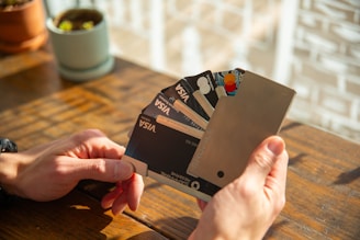 a person holding a credit card in their hand