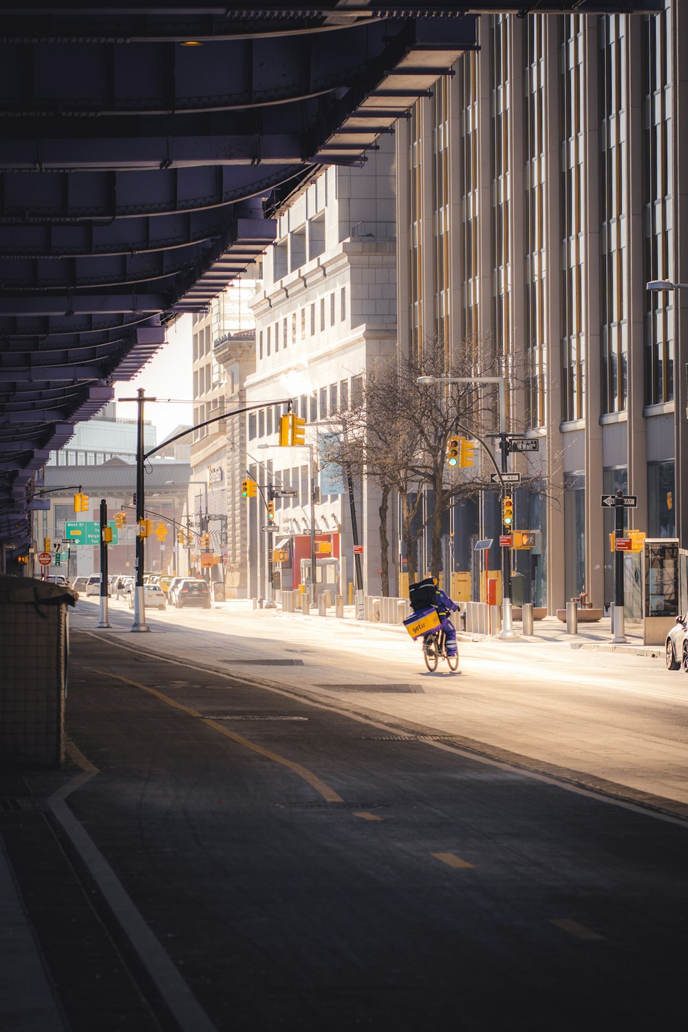 a person riding a bike down a city street