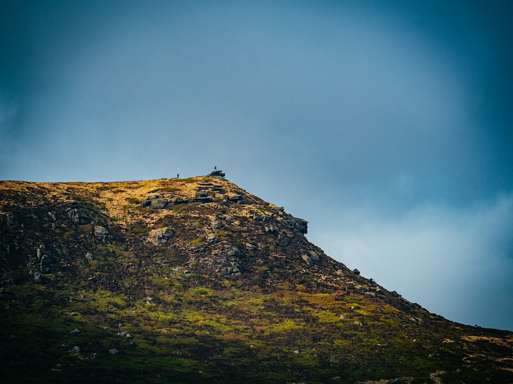 a hill with a person standing on top of it
