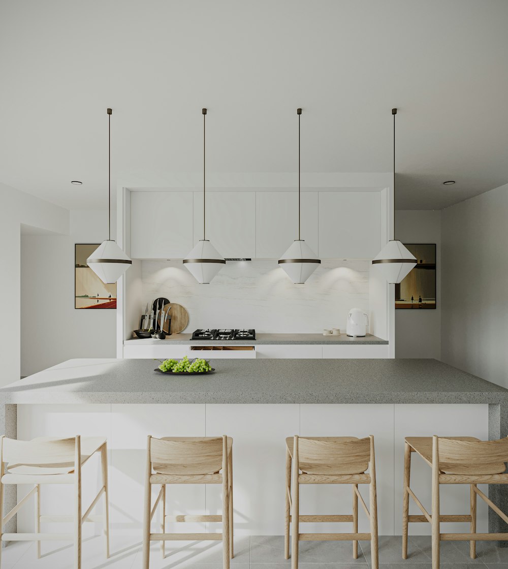 a kitchen with a center island surrounded by wooden chairs