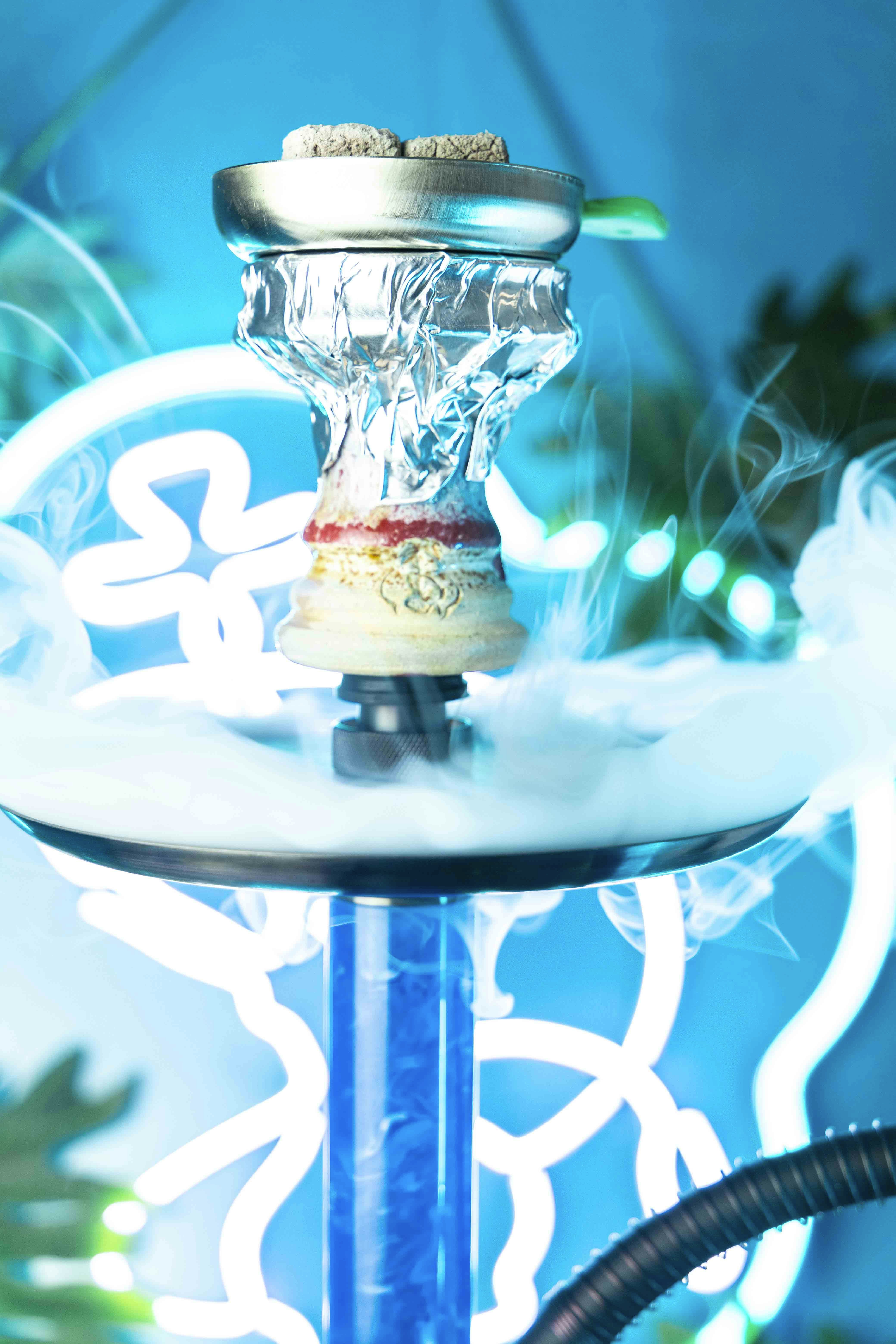 a close up of a water fountain with a blue background