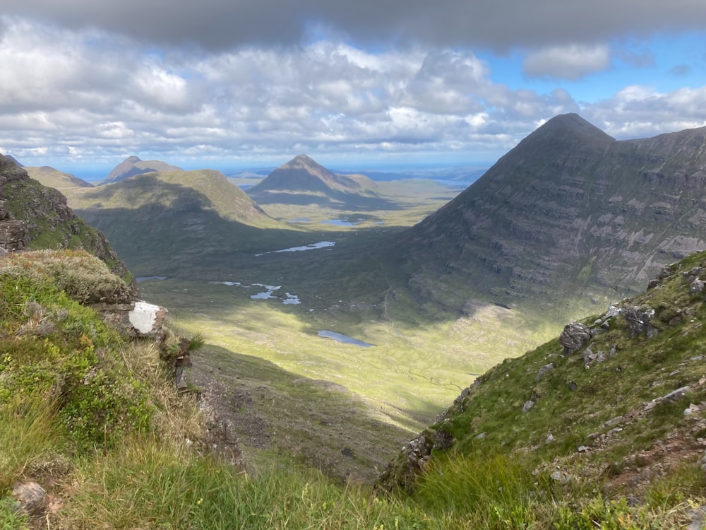 a view of a valley with mountains in the background