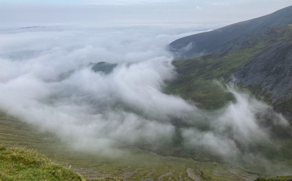 a view of a valley covered in thick clouds