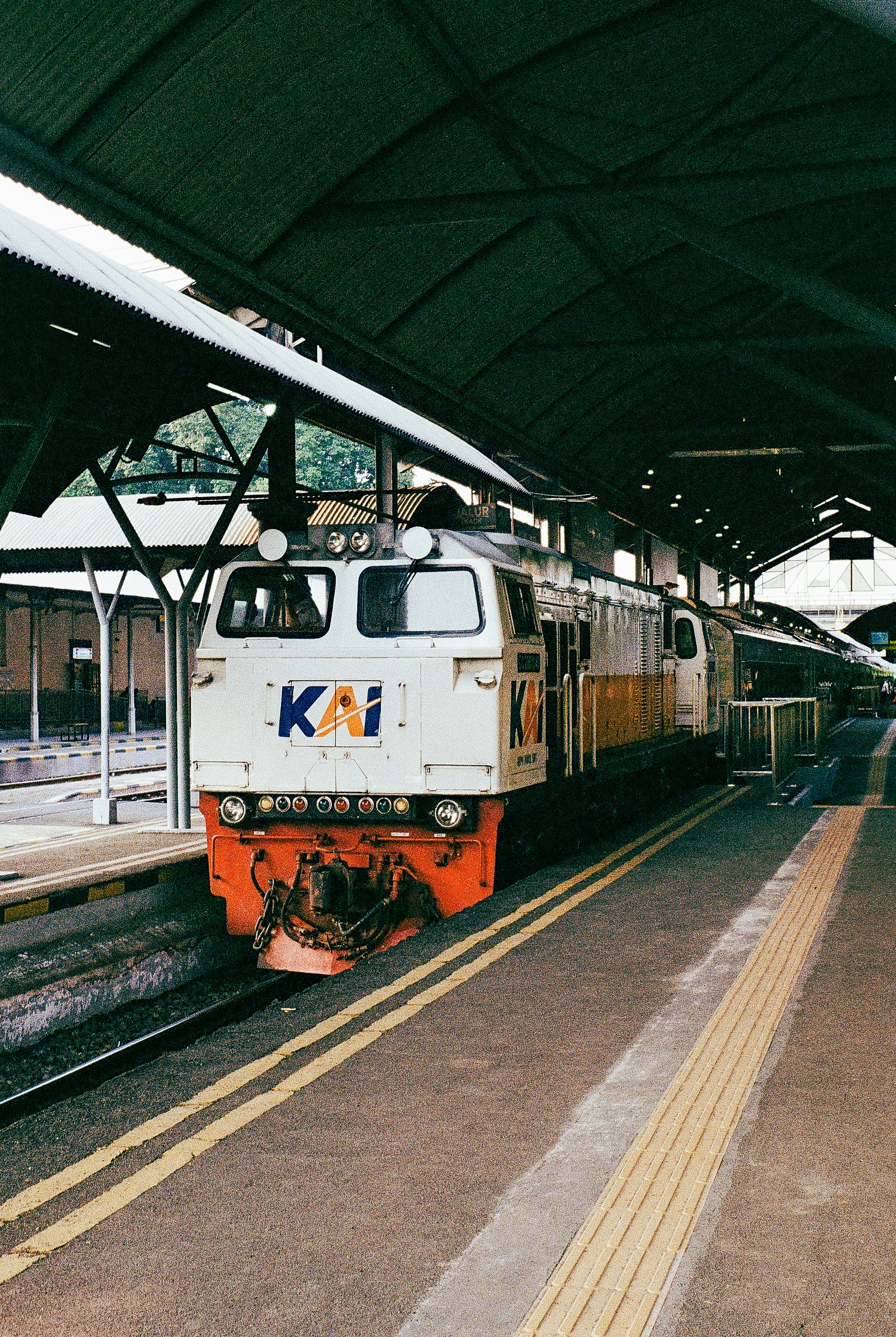 a train pulling into a train station next to a platform